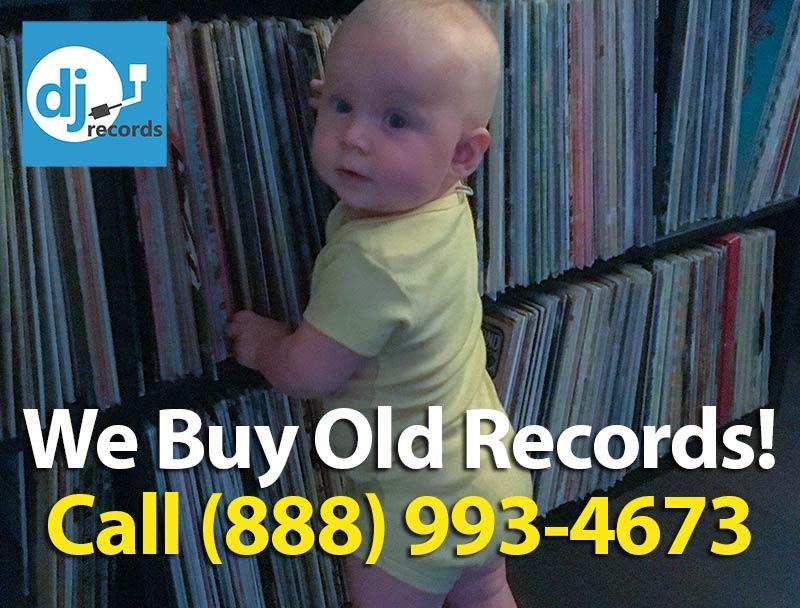 baby in front of vinyl records